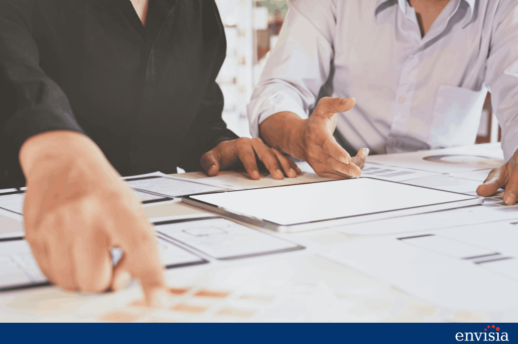 Team members reviewing 360 degree feedback scoring formats and report structure together at a desk